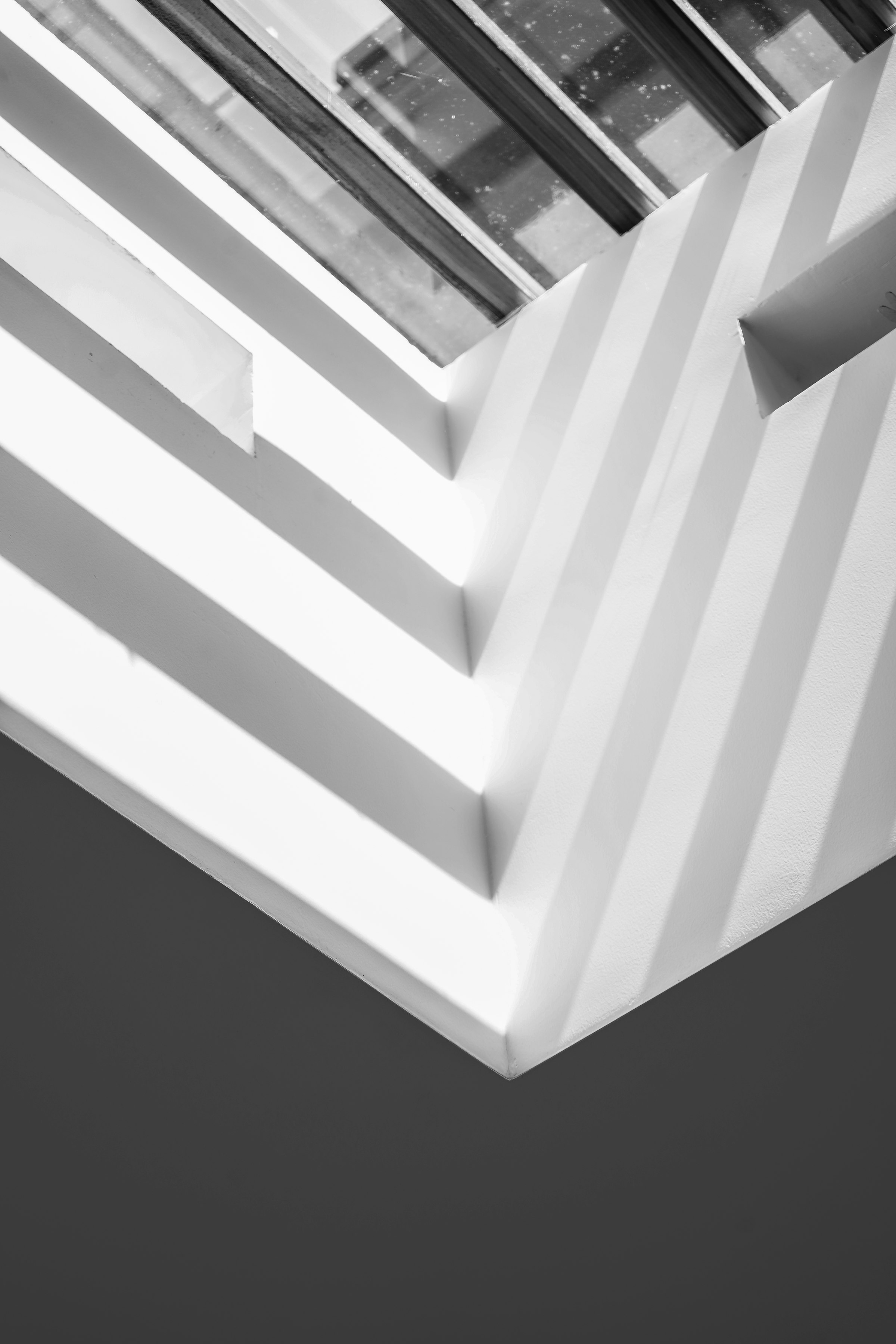 Abstract architectural lines with light and shadow, evoking continuous structure.