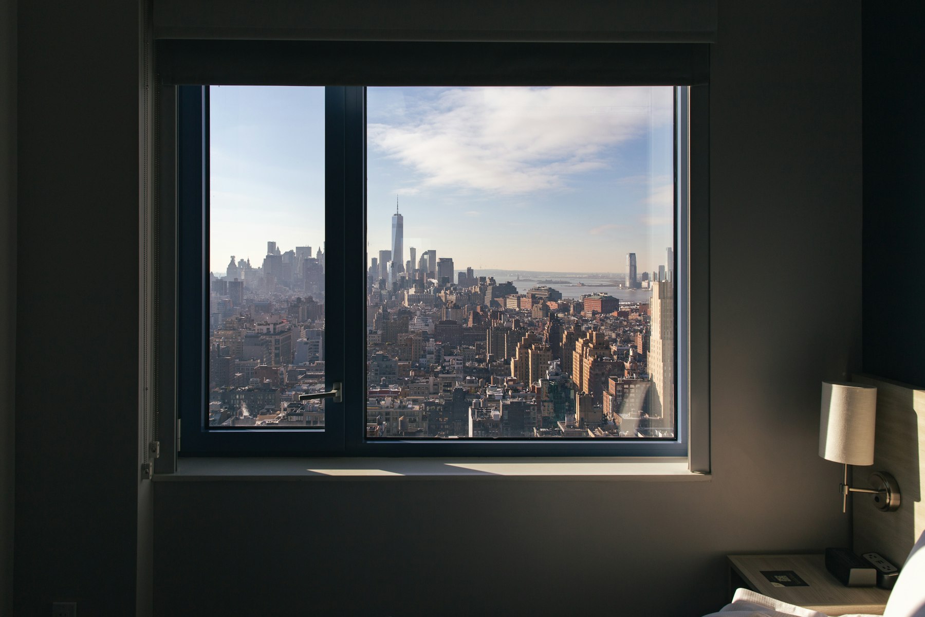 A city skyline seen through a high-rise window, evoking executive-level perspective.